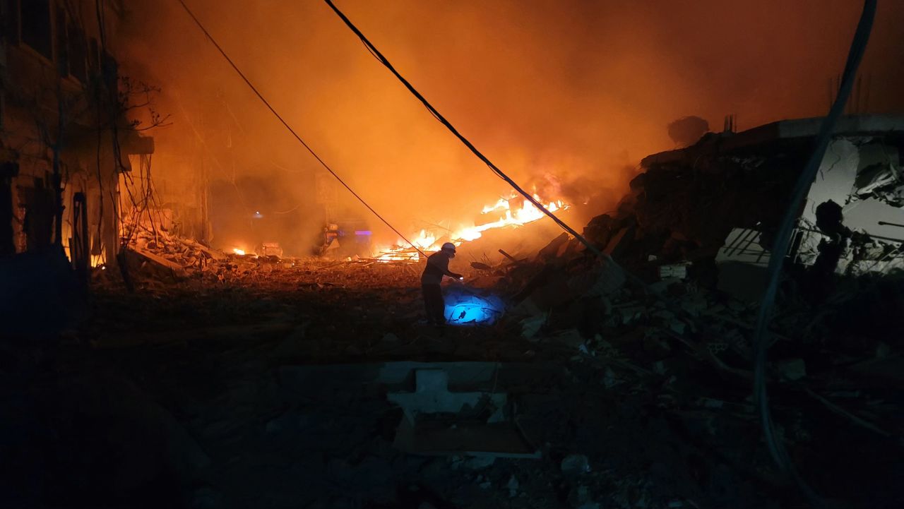 A rescuer searches for survivors at the site of an Israeli airstrike in Nabatiyeh, Lebanon, on October 12.