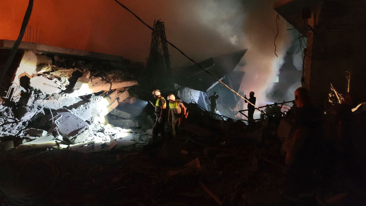 Rescuers search for survivors at the site of an Israeli airstrike that targeted the southern Lebanese city of Nabatieh on October 12.