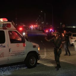 Emergency services personnel attend the scene of a drone strike on October 13, 2024 in Binyamina, Israel. Initial reports suggest at least 40 people were injured near Binyamina, Israel, following a drone strike launched by Hezbollah.