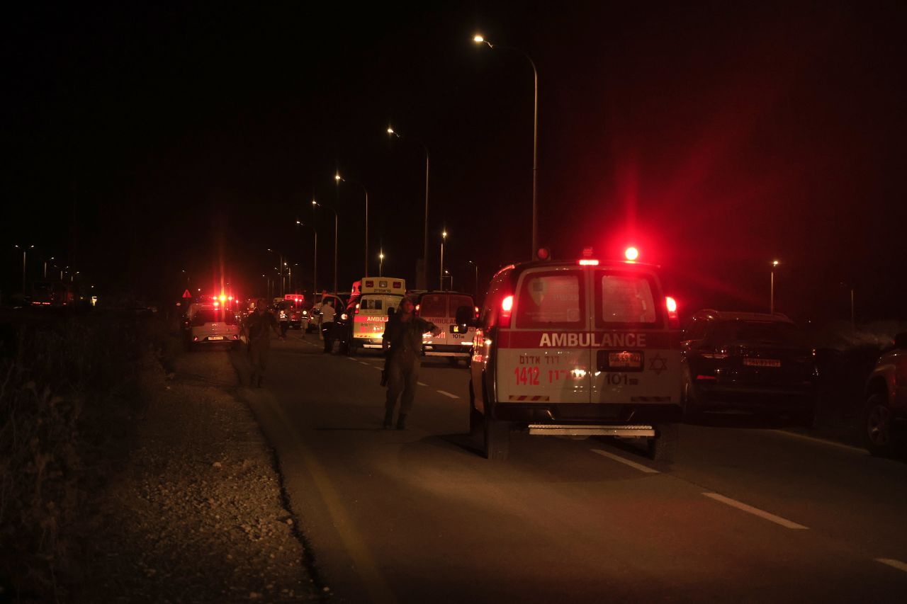 Emergency services personnel attend to the scene of a drone strike in Binyamina, Israel, on October 13.