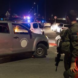 An Israeli soldier secures a road after a drone attack that caused mass casualties on October 13, 2024 in Binyamina, Israel. More than 60 people were reportedly injured near Binyamina, Israel, following a drone strike launched by Hezbollah.