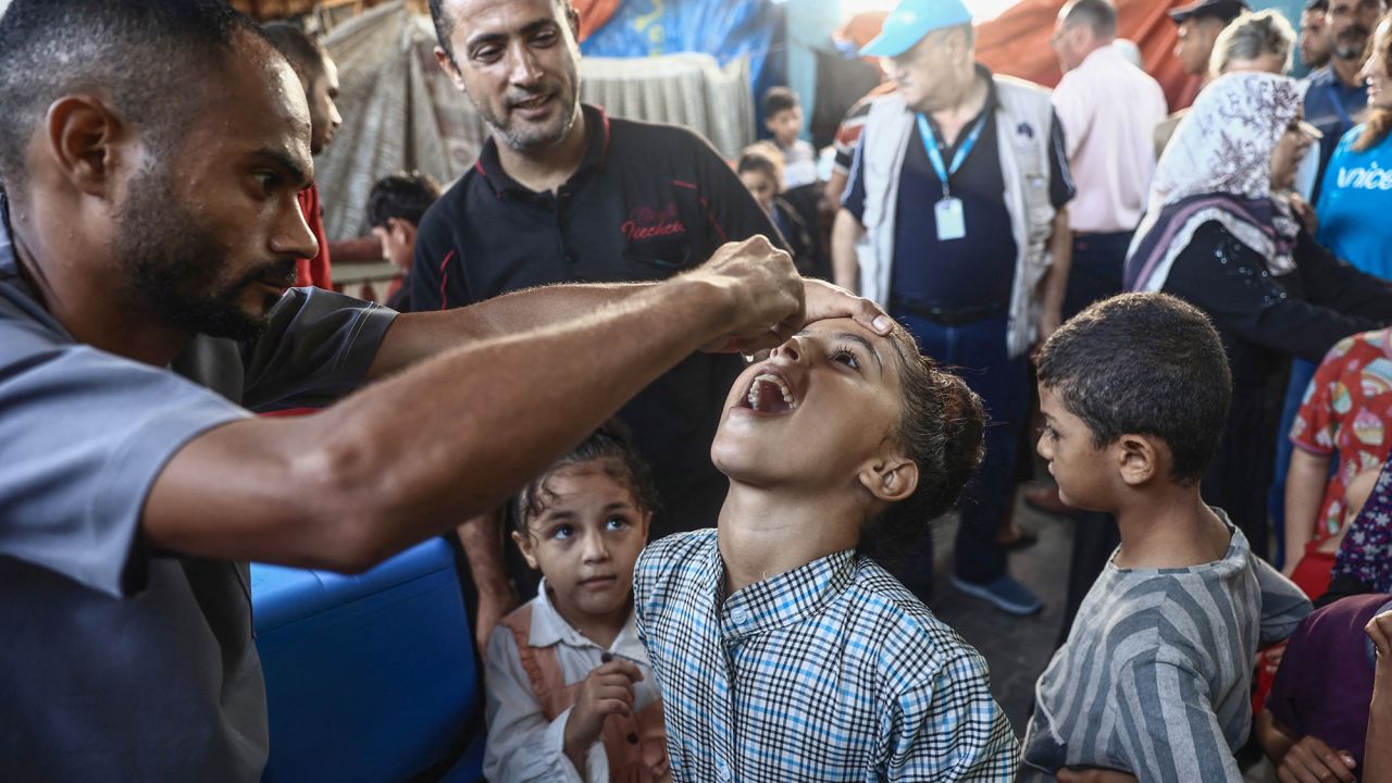 Palestinian children receive drops as part of a polio vaccination campaign, in Deir al-Balah, Gaza, on October 14.