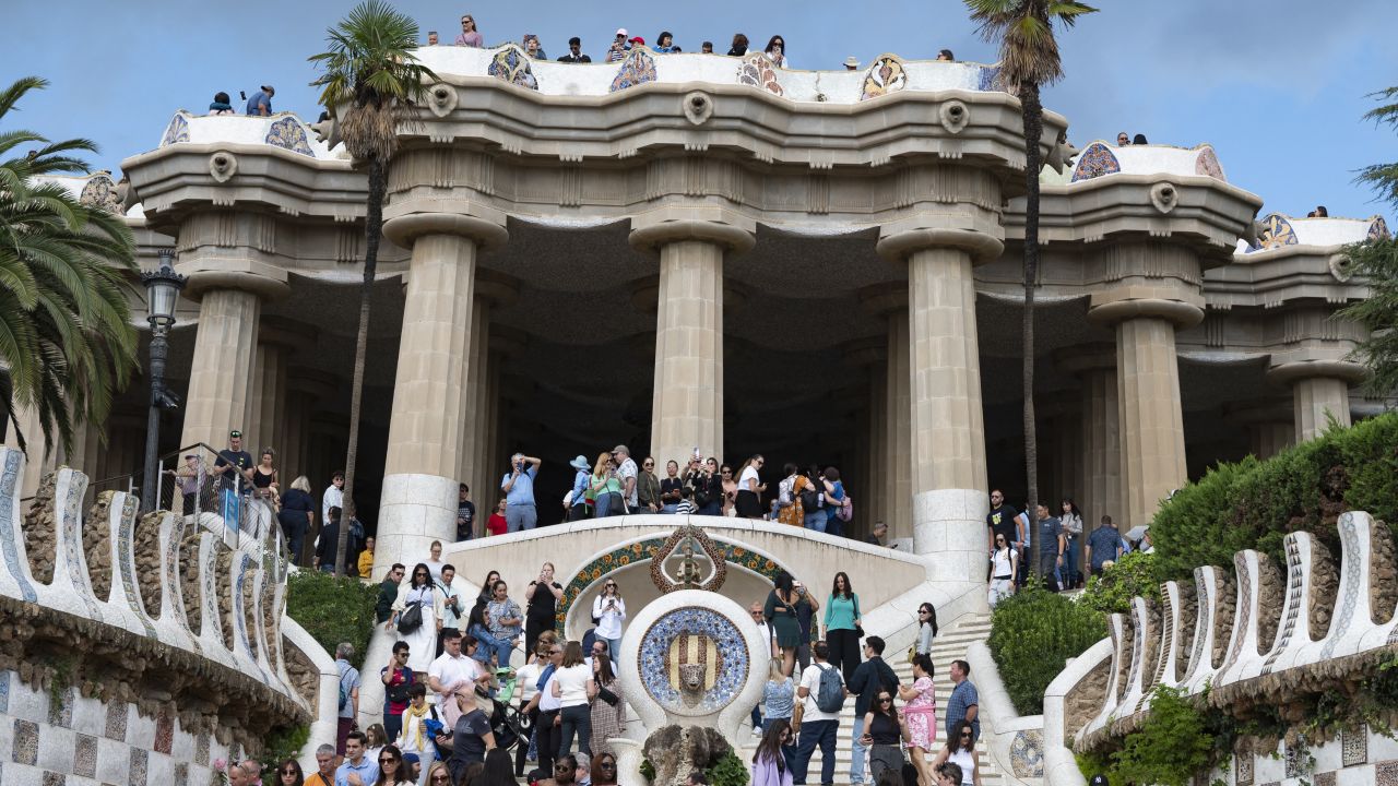 Tourists visit Park Guell in Barcelona on October 11, 2024. Tourists are flocking to Barcelona in ever increasing numbers, fueling anger among locals who complain that mass tourism in driving up housing prices and overwhelming public spaces in Spain's second city. (Photo by Josep LAGO / AFP) (Photo by JOSEP LAGO/AFP via Getty Images)