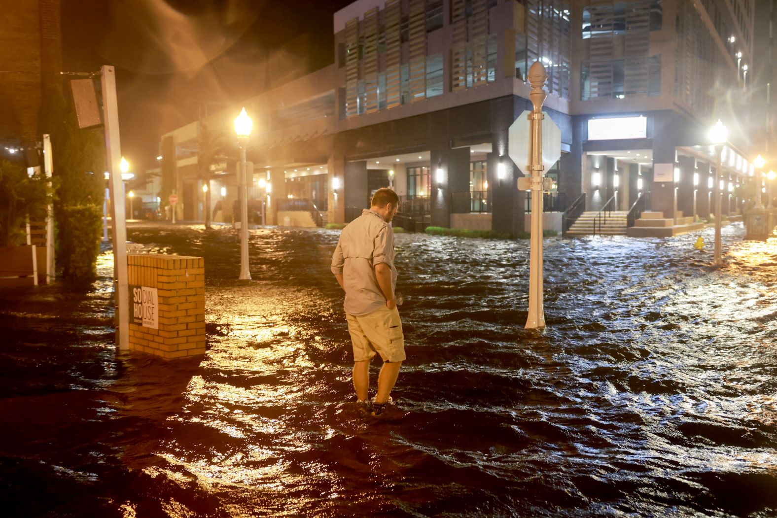 Brandon Marlow walks through a flooded street in Fort Myers, Florida, on Wednesday.