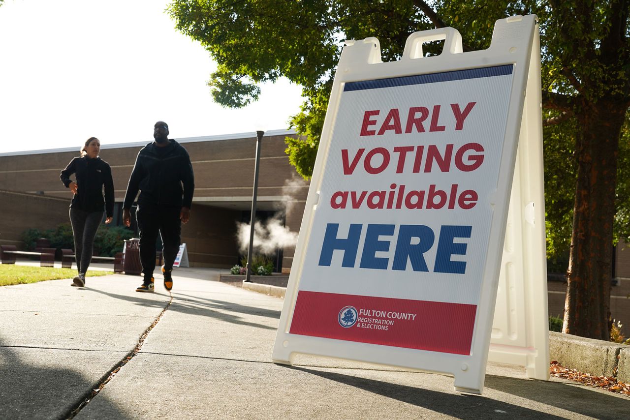 Signs direct people where to go to cast their votes on the first day of early voting at Atlanta Metropolitan State College on Tuesday, October 15, in Atlanta, Georgia.