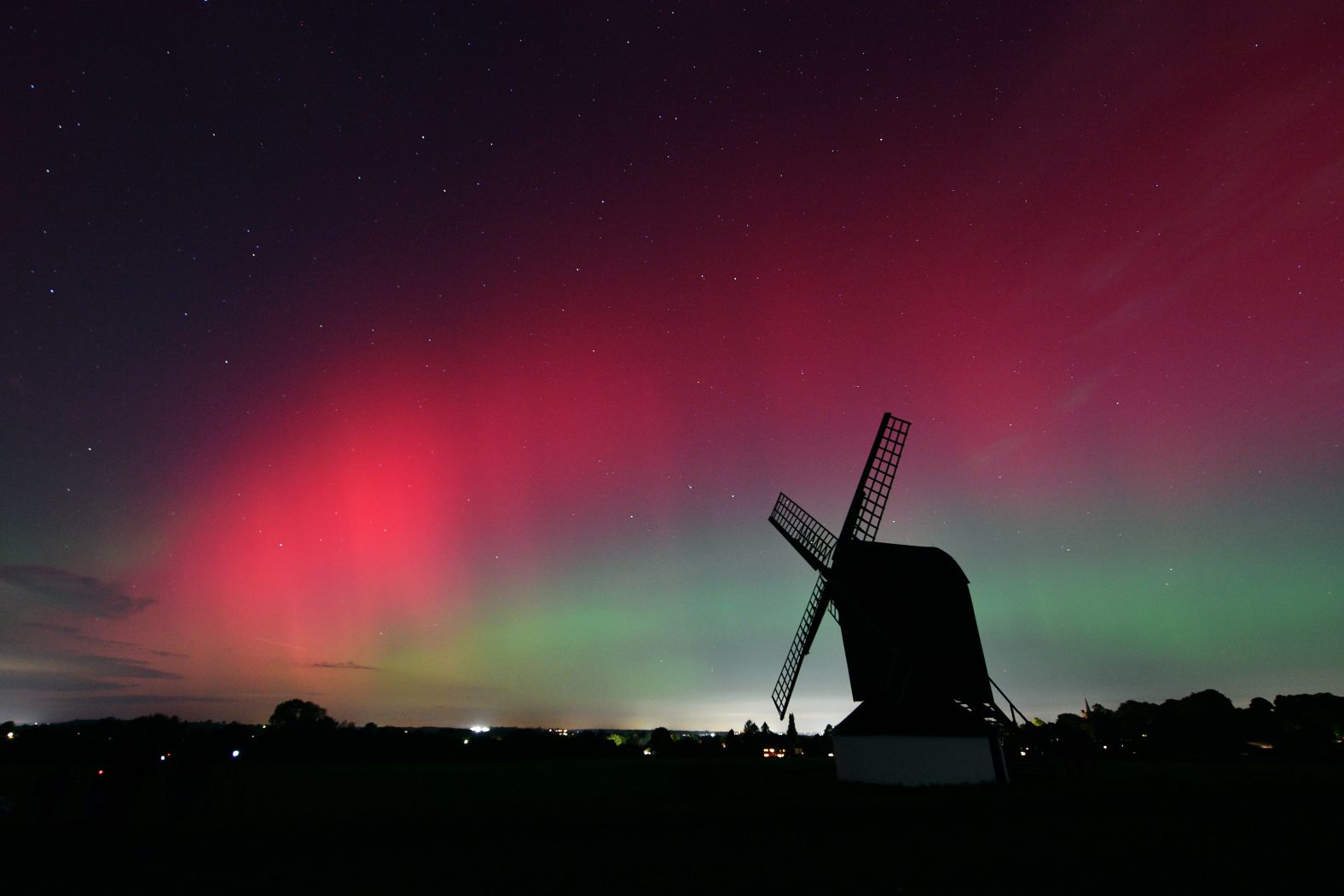 The Aurora borealis lights up the night sky Thursday over the Pitstone Windmill in Buckinghamshire, England.