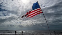 An American Flag is planted in the sand at Treasure Island as clean up from hurricanes Helene and Milton continues along the Gulf Coast on October 10, 2024 in Treasure Island, Florida.