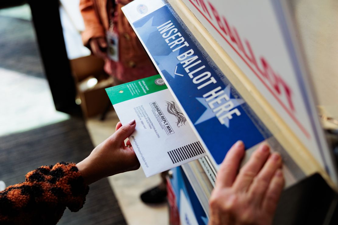 A person drops off a mail-in ballot on October 15, 2024, in Doylestown, Pennsylvania.