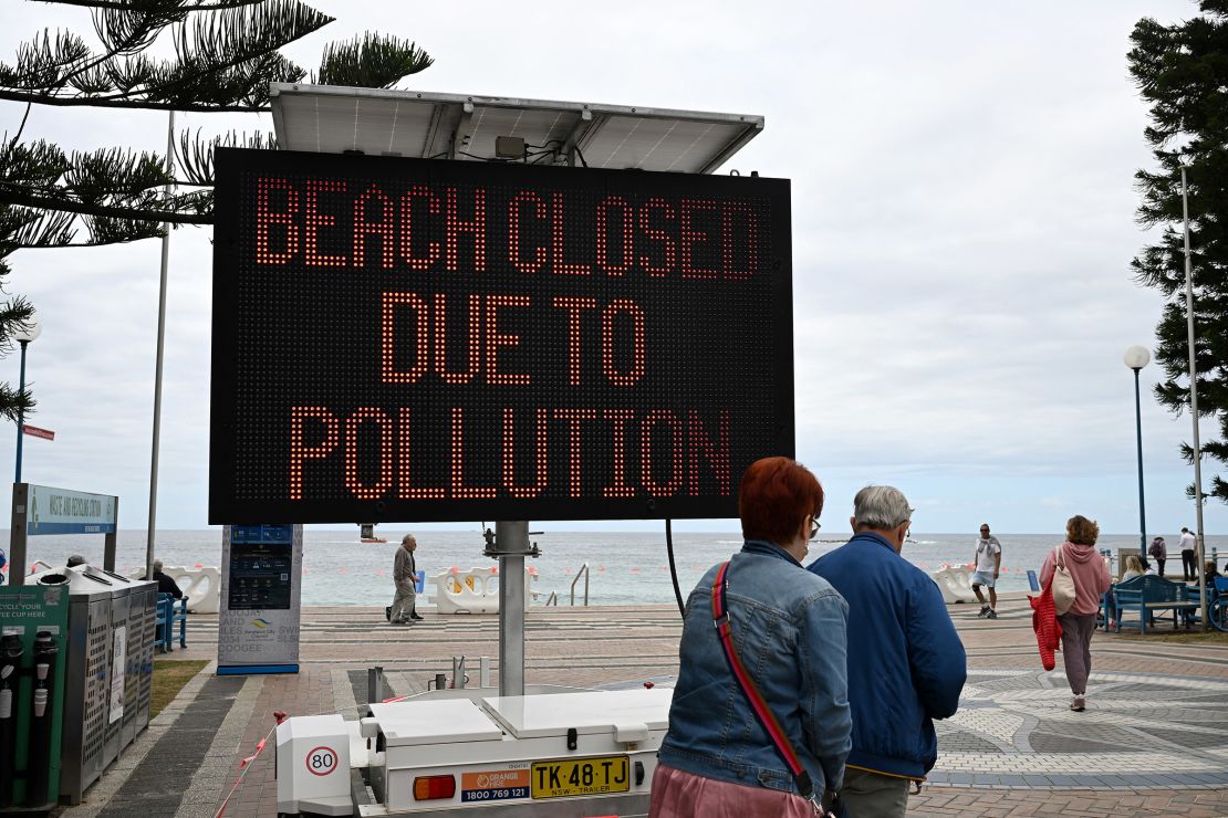 People visit Coogee Beach in Sydney, Australia after authorities closed it to the public on October 16, 2024, following the sighting of mysterious black balls on its shores.