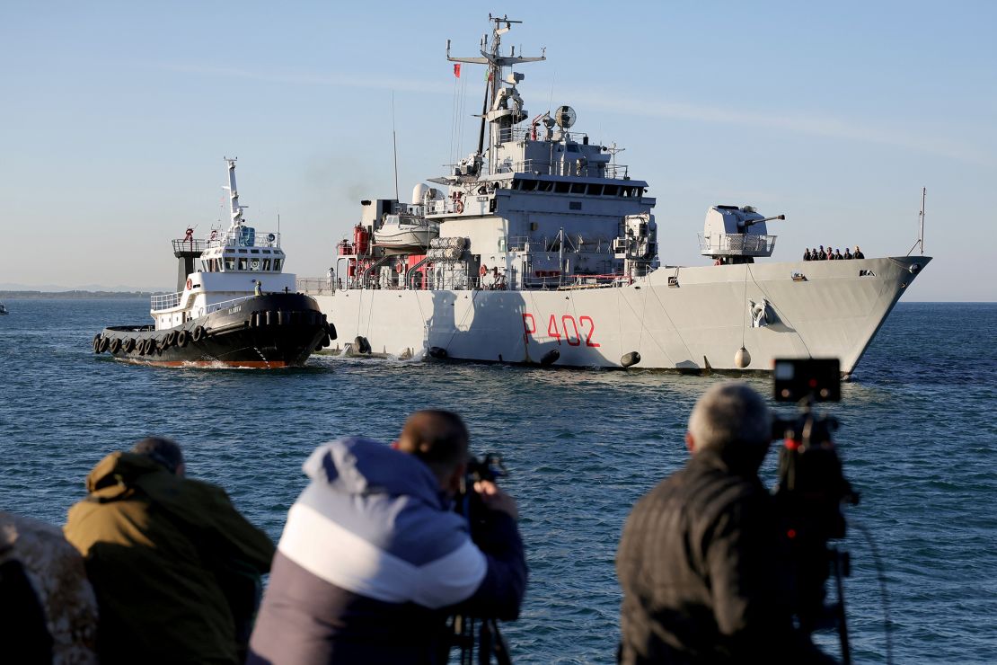 A navy boat carrying migrants intercepted in Italian waters arrives at a port in Albania on Wednesday.