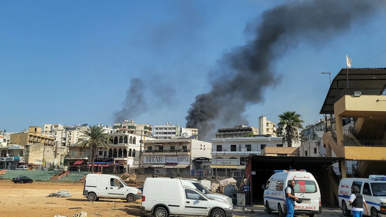 Rescuers at an emergency services center react as smoke billows during Israeli airstrikes in the southern Lebanese city of Nabatiyeh on Wednesday, October 16.