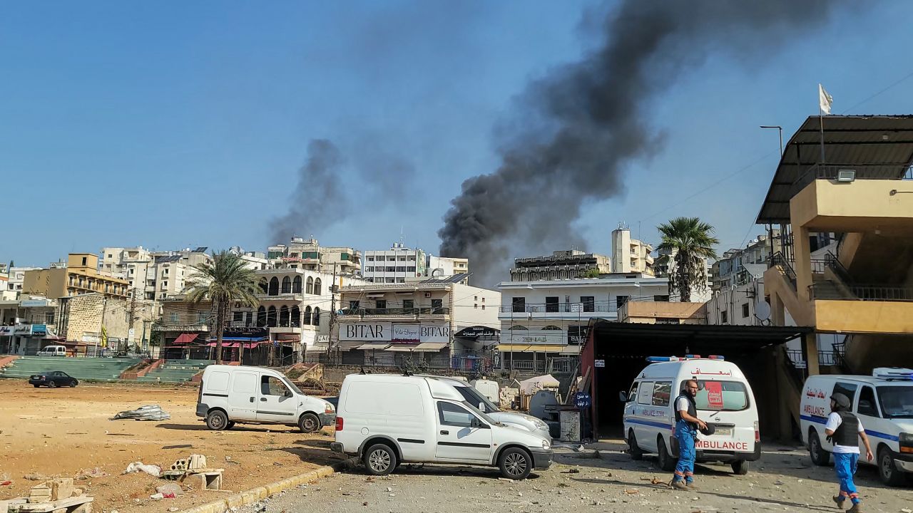 Rescuers at an emergency services center react as smoke billows during an Israeli airstrike in the southern Lebanese city of Nabatiyeh on October 16.