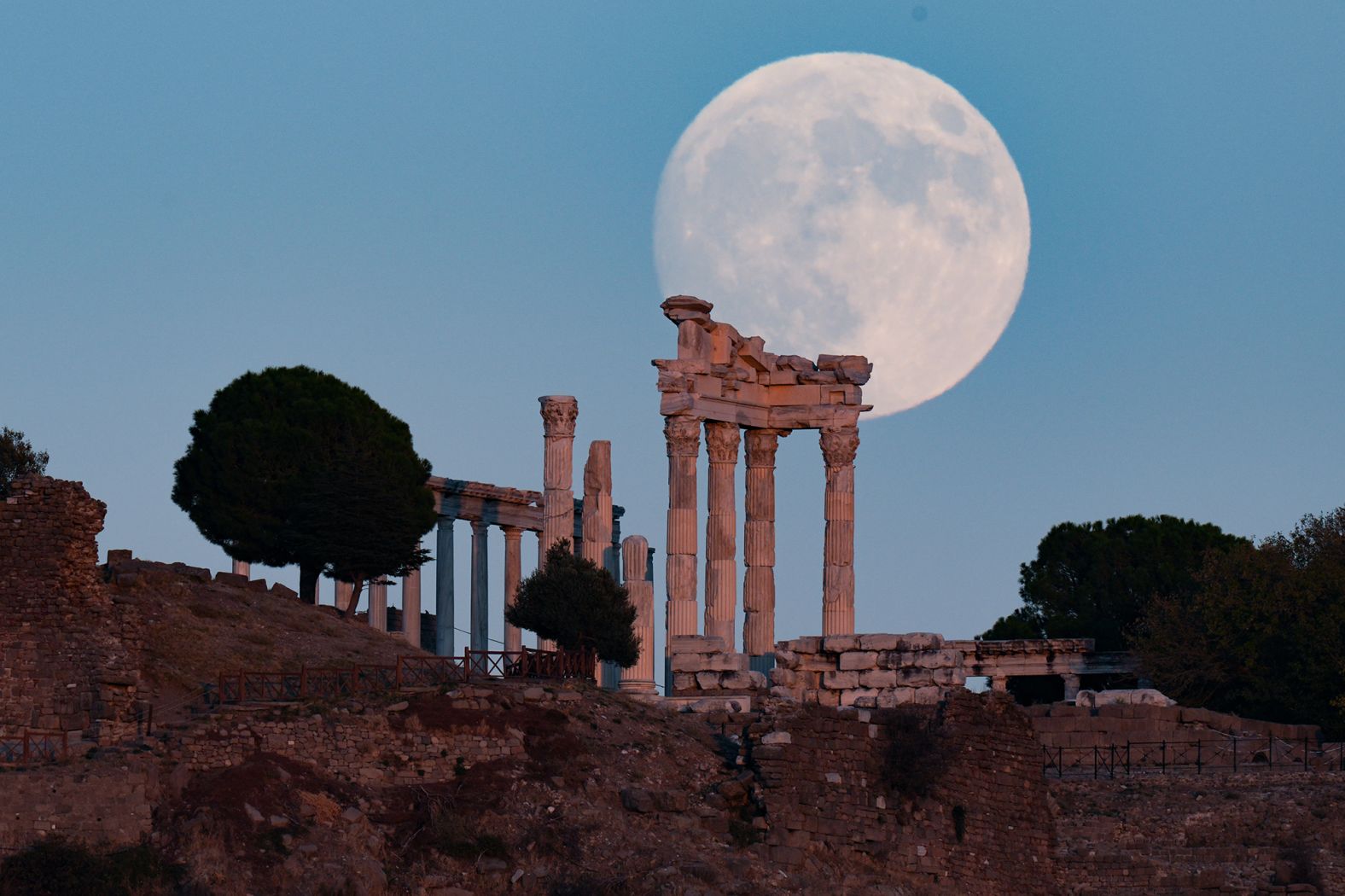 The moon rises behind the ancient Acropolis in the Bergama district of Izmir, Turkey, on Wednesday.