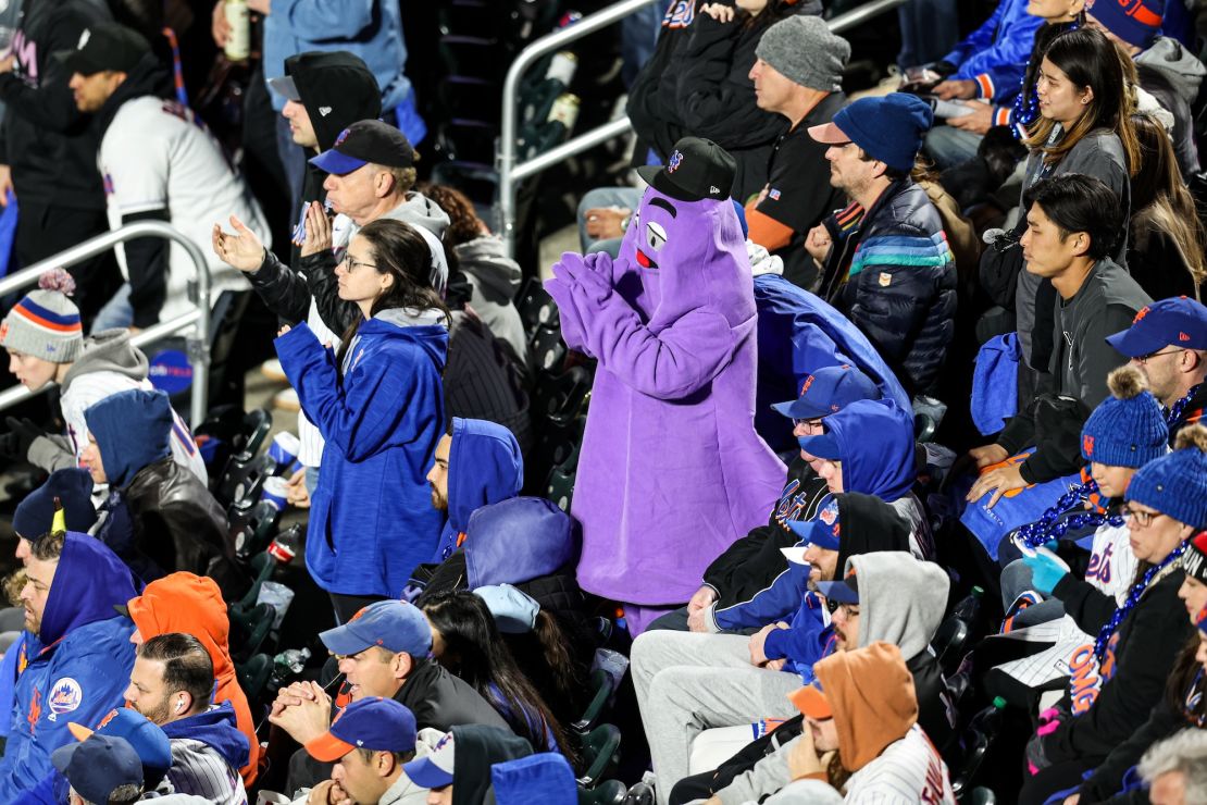 New York Mets fan dressed as Grimace celebrates the team forcing a Game 6 in NLCS.