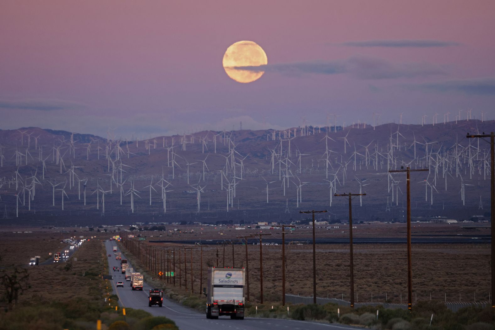 A hunter's moon sets over Mojave, California on October 17, 2024. According to the Old Farmer's Almanac, this week's supermoon will rotate as close as 222,055 miles (357,363 km) from Earth the closest position of the year, accounting for its luminousness. (Photo by David SWANSON / AFP) (Photo by DAVID SWANSON/AFP via Getty Images)