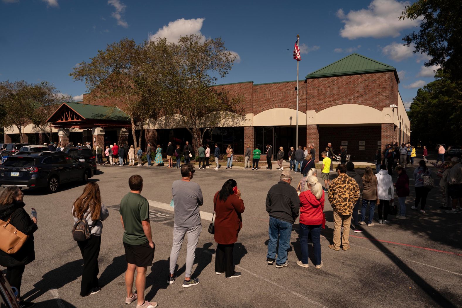 Voters wait in line as early voting begins in Wilmington, North Carolina, on October 17.