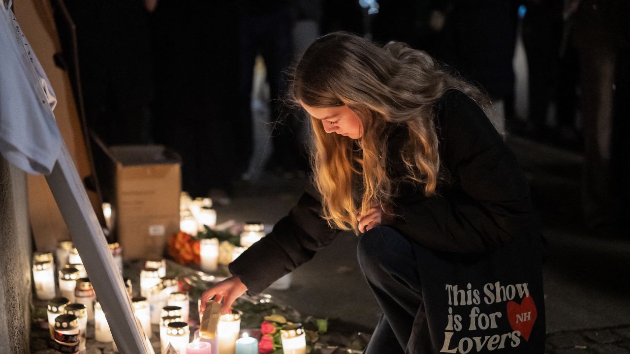 A fan lights a candle at a makeshift memorial in tribute to late British singer and former member of boy band One Direction, Liam Payne at the Forum in Copenhagen, Denmark on October 17, 2024. Payne, 31, died after falling from a third-floor balcony at a Buenos Aires hotel on Wednesday, October 16. The circumstances of the pop star's death, however, remain unclear. (Photo by Emil Nicolai Helms / Ritzau Scanpix / AFP) / Denmark OUT (Photo by EMIL NICOLAI HELMS/Ritzau Scanpix/AFP via Getty Images)