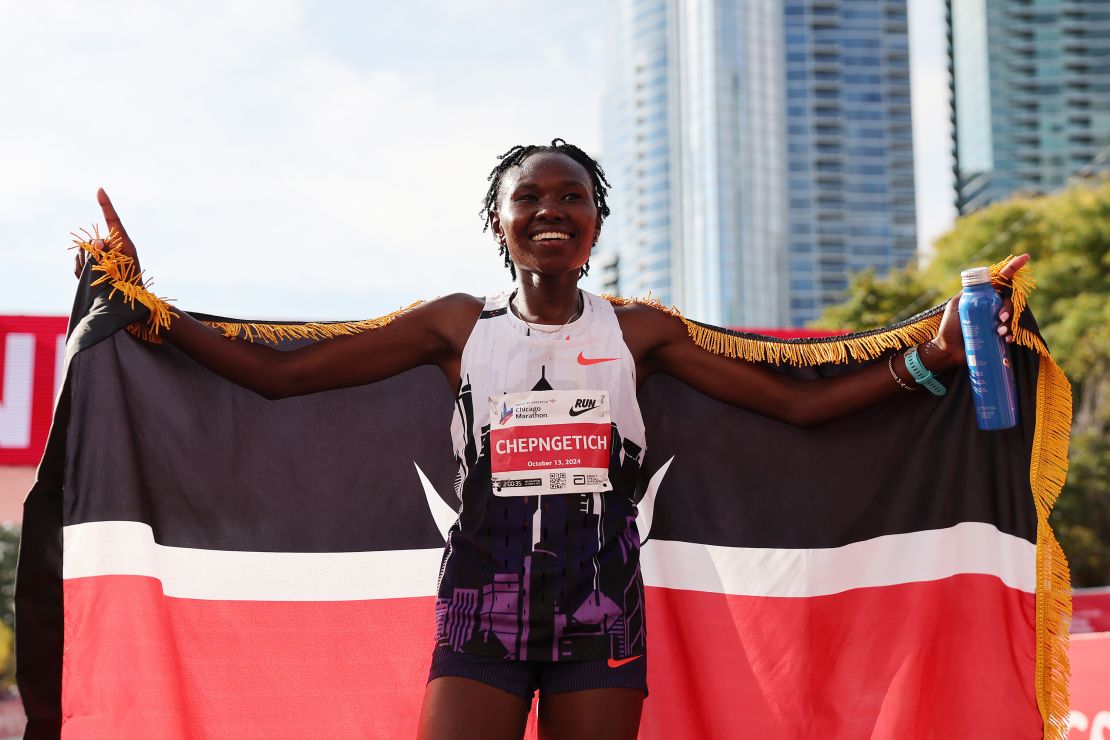 CHICAGO, ILLINOIS - OCTOBER 13: Ruth Chepngetich of Kenya celebrates after crossing the finish line to win the 2024 Chicago Marathon professional women's division and set a new world record with a time of 2:09:56 at Grant Park on October 13, 2024 in Chicago, Illinois. (Photo by Michael Reaves/Getty Images)