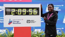 Ruth Chepngetich of Kenya poses with a clock after the 2024 Chicago Marathon professional women's division on October 13, 2024.