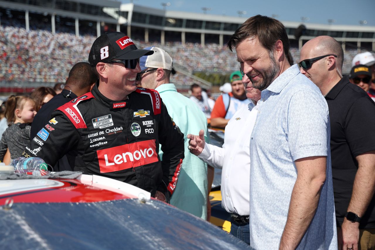 Republican vice presidential nominee JD Vance, right, speaks to #8 Lenovo Chevrolet driver Kyle Busch at Charlotte Motor Speedway in Concord, North Carolina, on October 13.