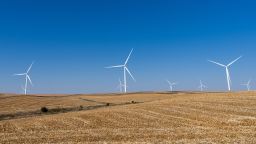 Wind turbines stand in a corn field in rural Iowa on October 17, 2024.