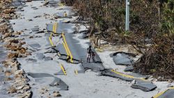 MANASOTA KEY, FLORIDA - OCTOBER 13: In an aerial view, a bicycle rider navigates a damaged road along the Gulf of Mexico on October 13, 2024 in Manasota Key, Florida. People continue recovering following the storm that made landfall as a Category 3 hurricane in the Siesta Key area of Florida on October 9th, causing damage and flooding throughout Central Florida. (Photo by Joe Raedle/Getty Images)