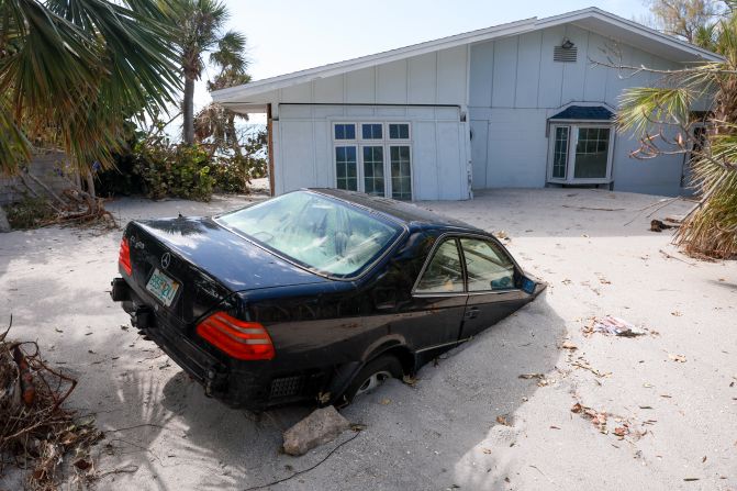 A vehicle is seen stuck in beach sand in Manasota Key, Florida, on Sunday.