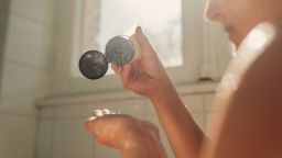 Woman putting hair shampoo on her hand , ready to hair washing.