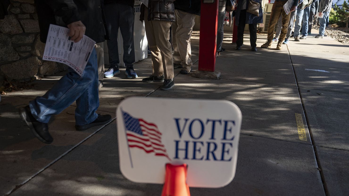 People wait in line to cast their ballots during early voting at a polling station in Black Mountain, North Carolina, on October 18, 2024.