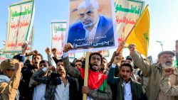 Supporters of Yemen's Huthis chant slogans as they gather with a picture of Hamas' slain leader Yahya Sinwar during a rally held in the Huthi-controlled capital Sanaa on October 18, 2024 in protest against Israel's attacks on Lebanon and the ongoing war between Israel and Hamas militants in the Gaza Strip. Israel announced on October 17 the killing of Sinwar, mastermind of the October 7 attack, calling his death a "heavy blow" to the Palestinian group it has been fighting for more than a year. (Photo by Mohammed HUWAIS / AFP) (Photo by MOHAMMED HUWAIS/AFP via Getty Images)