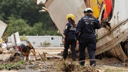 Members of the FEMA Urban Search and Rescue Task Force search a flood damaged area with a search canine in the aftermath of Hurricane Helene along the Swannanoa River on October 4, 2024 in Asheville, North Carolina.