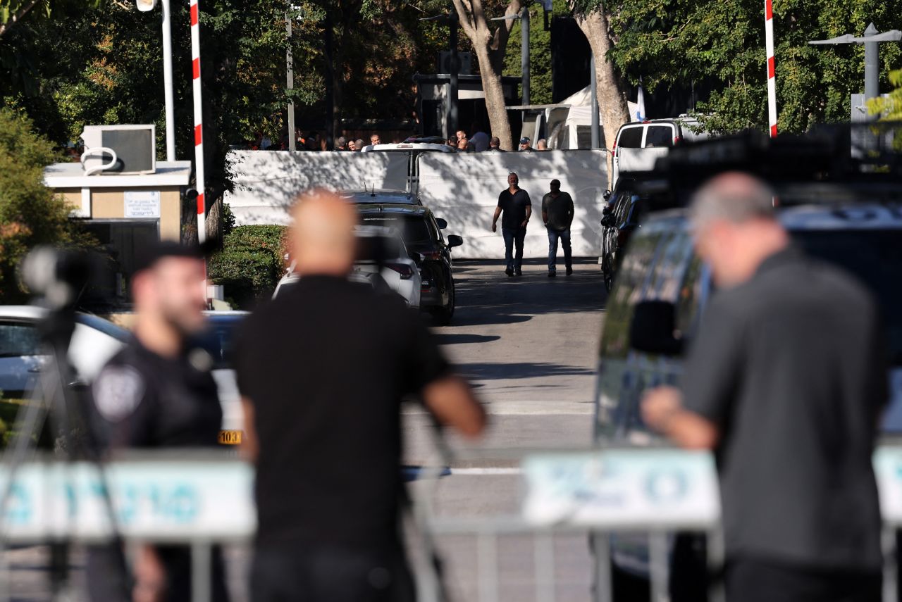 Israeli security forces gather behind a barrier across a street leading to Prime Minister Benjamin Netanyahu's residence in Caesarea, Israel, on October 19.