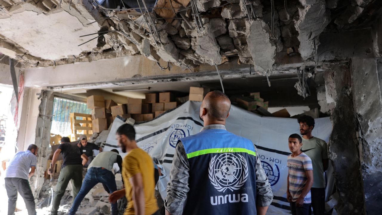 A UNRWA worker and displaced Palestinians check the damage inside a UN school-turned-refuge in the Al-Shati refugee camp near Gaza City following a reported Israeli strike on October 19.