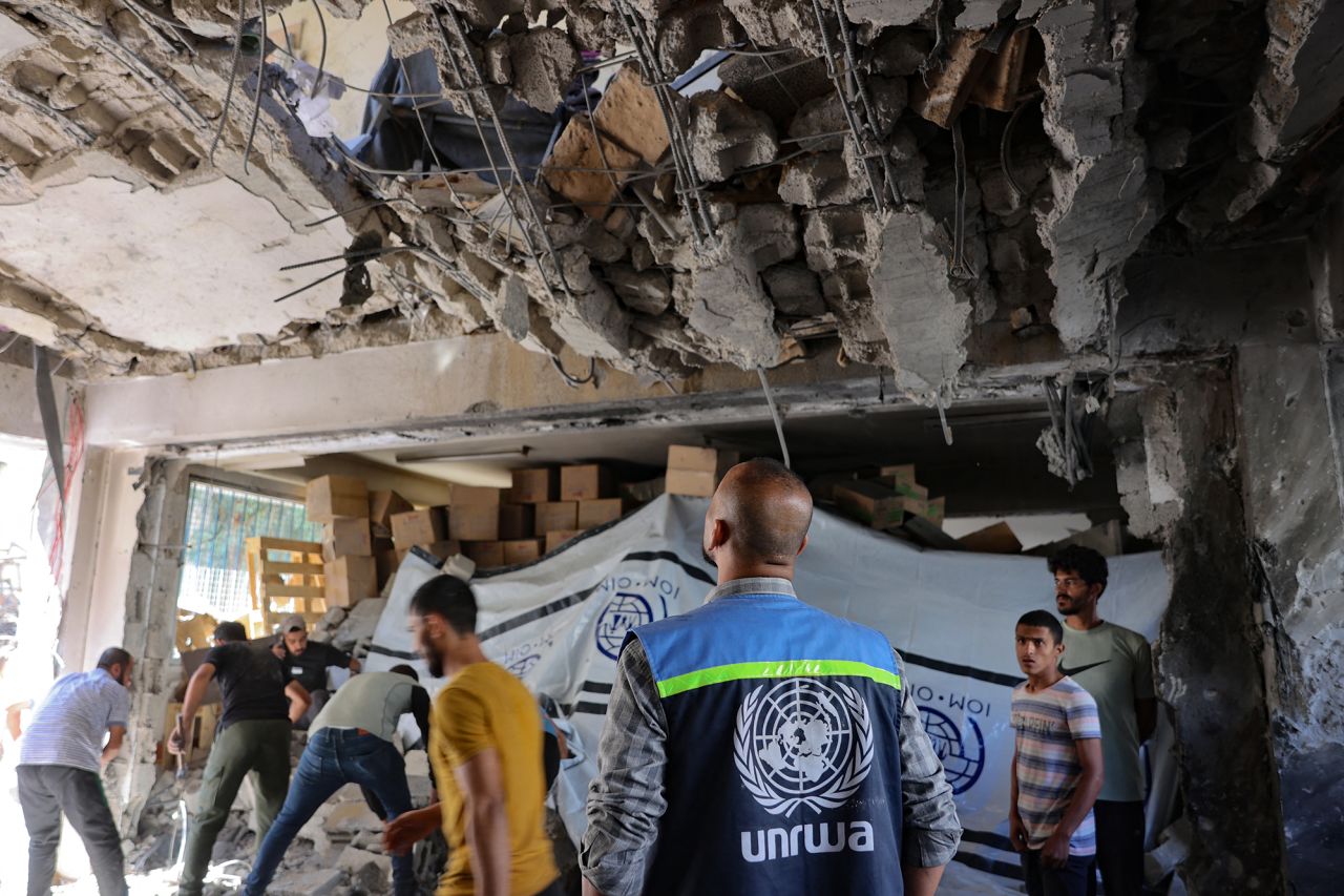 A UNRWA worker and displaced Palestinians check the damage inside a UN school-turned-refuge in the Al-Shati refugee camp near Gaza City following a reported Israeli strike on October 19.