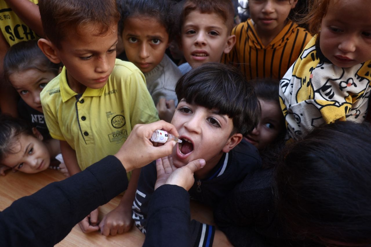 A medic administers a polio vaccine to a Palestinian child in Khan Younis, Gaza, on Saturday.