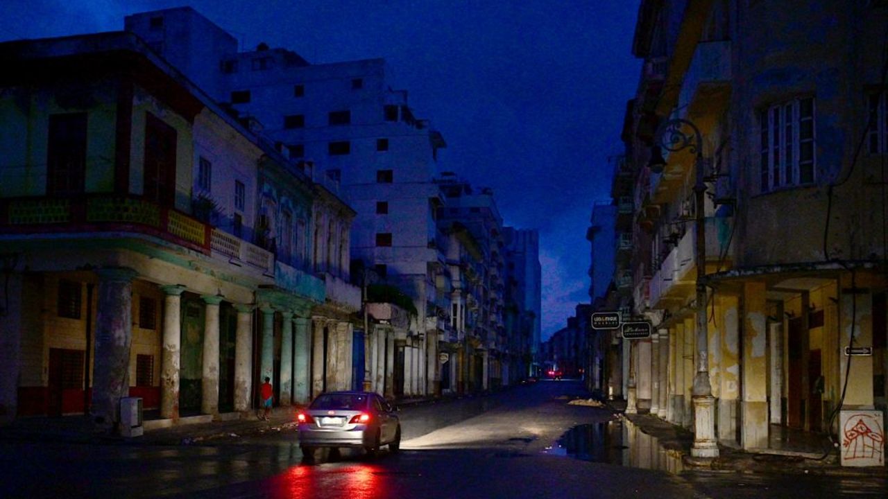 TOPSHOT - A car drives along a street during a nationwide blackout caused by a grid failure in Havana, on October 19, 2024. Technical breakdowns, fuel shortages and high demand have caused the country's thermoelectric power plants to constantly fail, forcing the government to declare an energy emergency and take measures such as closing schools and factories. (Photo by ADALBERTO ROQUE / AFP) (Photo by ADALBERTO ROQUE/AFP via Getty Images)