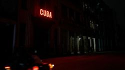 TOPSHOT - A sign lits a blacked out street during the second day of the nationwide blackout in Havana October 19, 2024. Hurricane Oscar is due to hit the island of Cuba imminently, with the risk of further affecting the population, who are spending their second night without electricity due to a giant blackout. (Photo by ADALBERTO ROQUE / AFP) (Photo by ADALBERTO ROQUE/AFP via Getty Images)