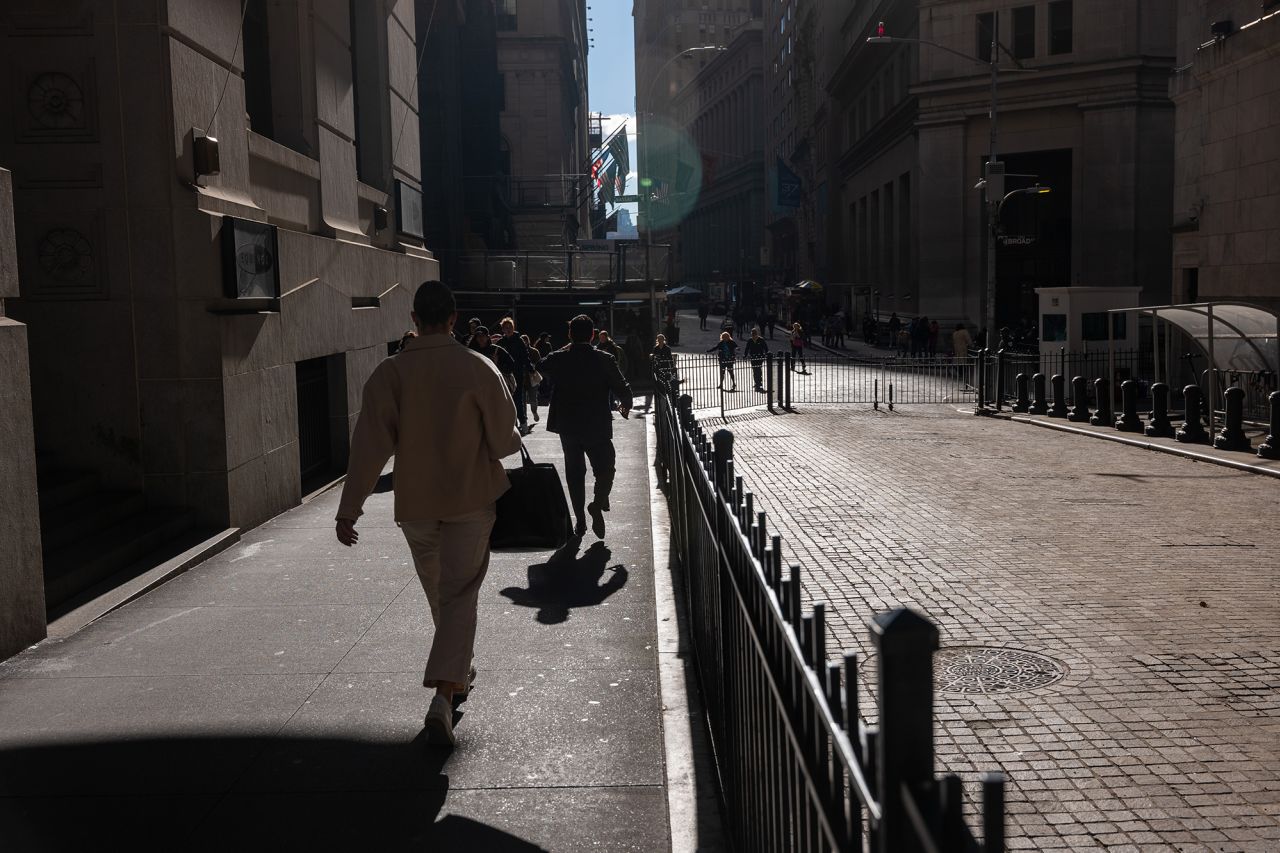 People walk outside of the New York Stock Exchange (NYSE) on October 16, 2024 in New York City.