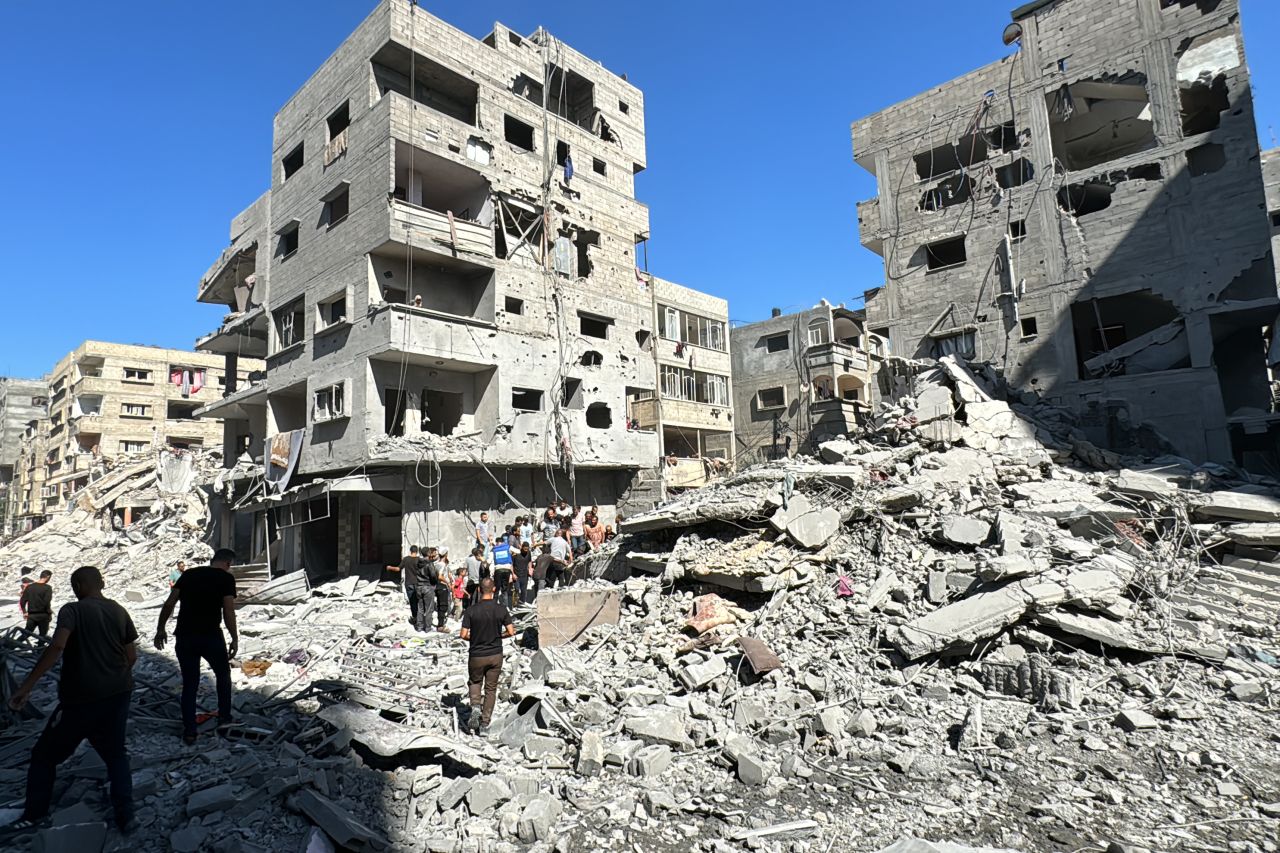 Palestinians inspect the damage after an Israeli airstrike the previous night in Beit Lahia, Gaza, on October 20.