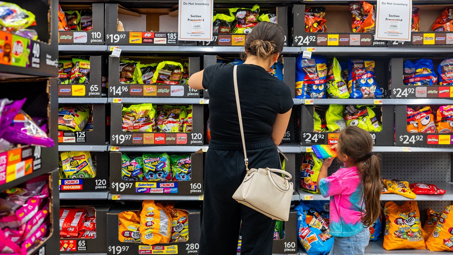 A family shops for Halloween candy at a Walmart Supercenter on October 16, 2024 in Austin, Texas. Candy companies have begun shifting to non-chocolate candies as chocolate makers deal with shrinking margins and a decrease in sales.