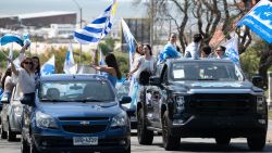 Supporters of Uruguay's presidential candidate for the Nacional party, Alvaro Delgado, attend a campaign rally in Montevideo on October 20, 2024. Uruguay will hold presidential elections on October 27. (Photo by Santiago MAZZAROVICH / AFP) (Photo by SANTIAGO MAZZAROVICH/AFP via Getty Images)