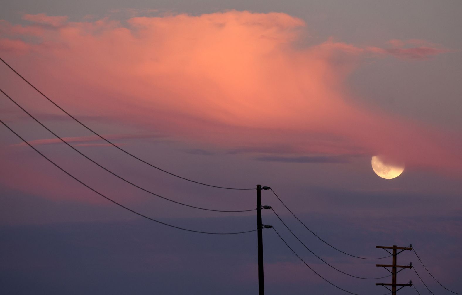 The moon rises near Lancaster, California, on Wednesday.