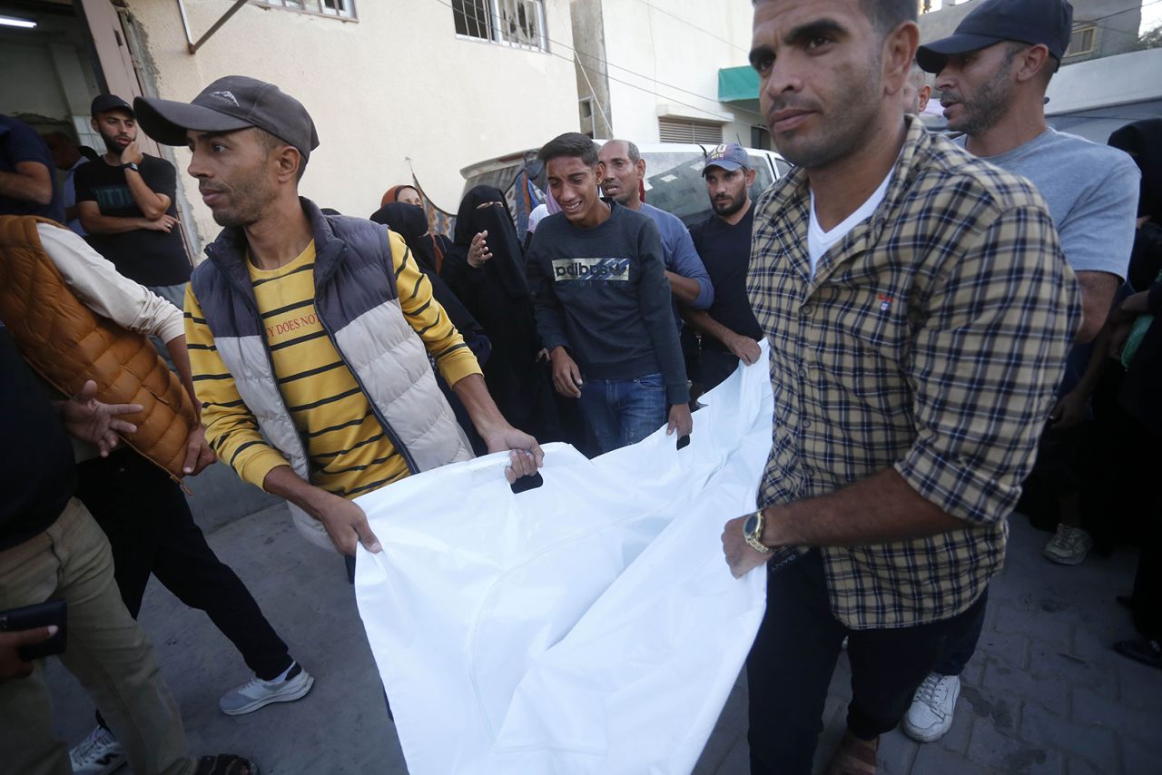 Palestinians carry the bodies wrapped in shroud to Al-Aqsa Martyrs Hospital after an Israeli attack on Deir al Balah, Gaza on October 20.