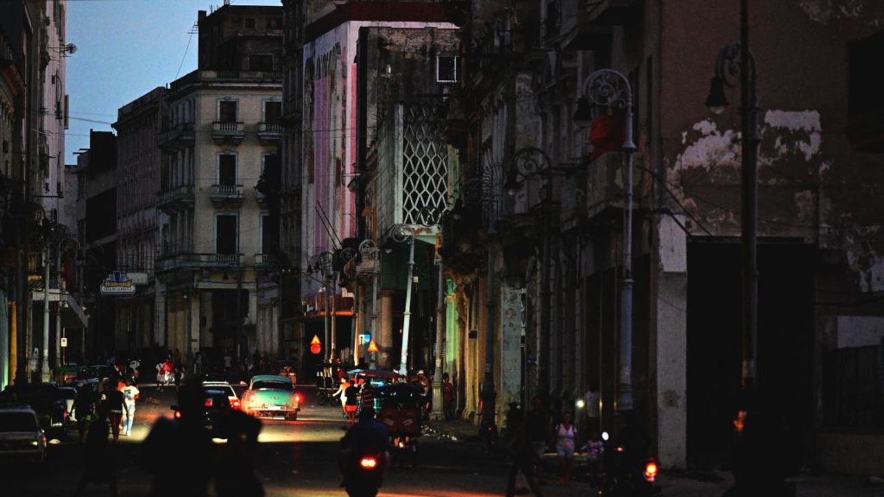 A street is lit by car lights during the third night of a nationwide blackout in Havana October 20, 2024. Cuban President Miguel Diaz-Canel warned Sunday that he will act with "rigor" against those who try to disrupt public order, amid a total blackout that has kept the island in darkness for three nights. (Photo by ADALBERTO ROQUE / AFP) (Photo by ADALBERTO ROQUE/AFP via Getty Images)