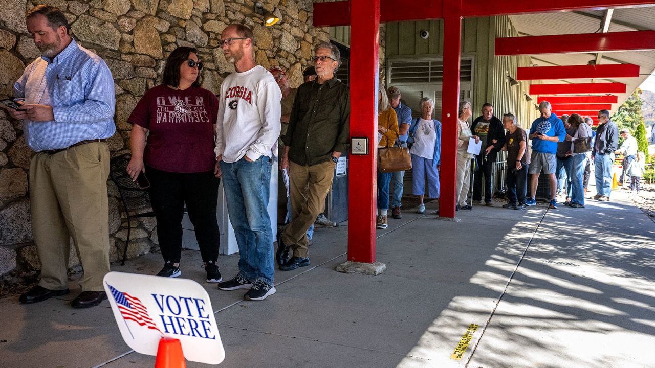 People line up for early voting at a polling station at the Black Mountain Public Library in Black Mountain, North Carolina on October 21, 2024.