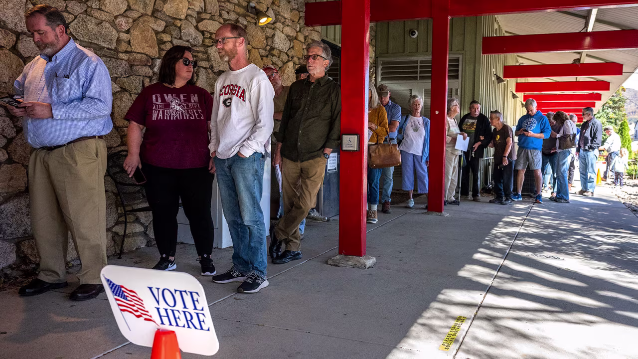 People line up for early voting at a polling station at the Black Mountain Public Library in Black Mountain, North Carolina, on October 21.