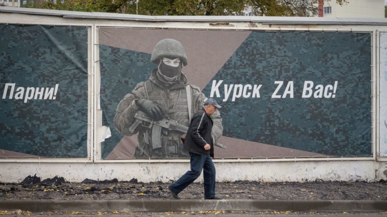 A man walks past a wall adorned with banners honouring Russian servicemen participating in Russia's military action in Ukraine, in Kursk on October 17, 2024. (Photo by Andrey BORODULIN / AFP) (Photo by ANDREY BORODULIN/AFP via Getty Images)