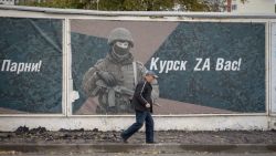 A man walks past a wall adorned with banners honouring Russian servicemen participating in Russia's military action in Ukraine, in Kursk on October 17, 2024. (Photo by Andrey BORODULIN / AFP) (Photo by ANDREY BORODULIN/AFP via Getty Images)