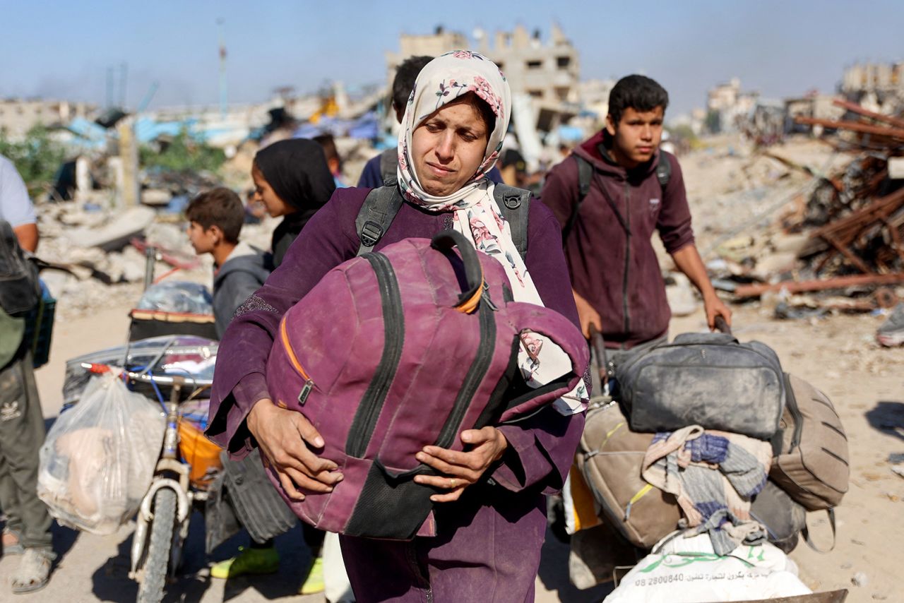 Displaced Palestinians fleeing Israeli military operations in Beit Lahia, in northern Gaza, walk along the Salah al-Din main road in eastern Gaza City, making their way to the city centre, on October 22, 2024.