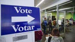 First voters wait in line to cast their votes at an early voting polling location at the Madison Public Library  Central in Madison, Wisconsin, on October 22, 2024. (Photo by KAMIL KRZACZYNSKI / AFP) (Photo by KAMIL KRZACZYNSKI/AFP via Getty Images)